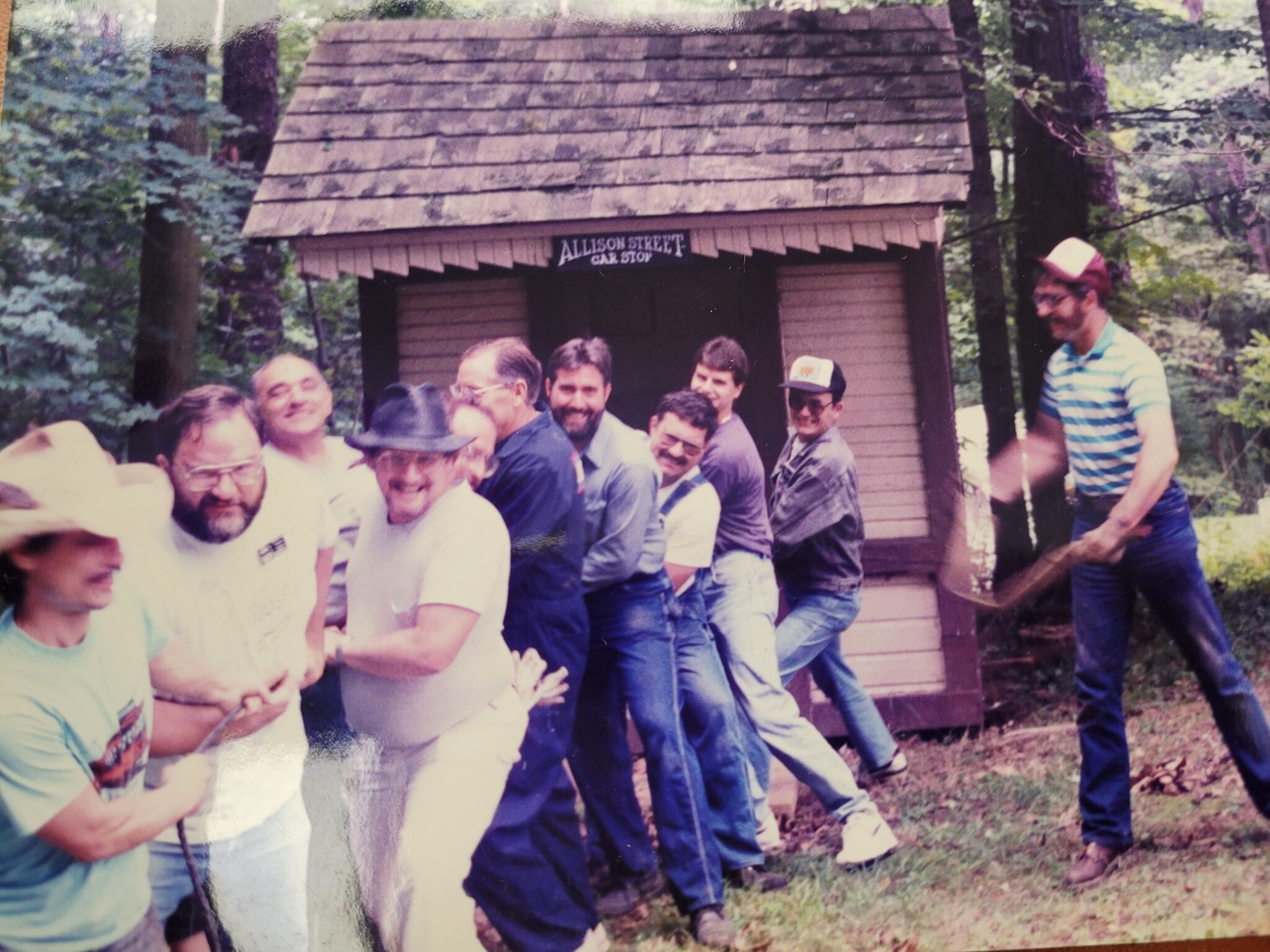 1990s photo of a group of men moving the Allison shelter
