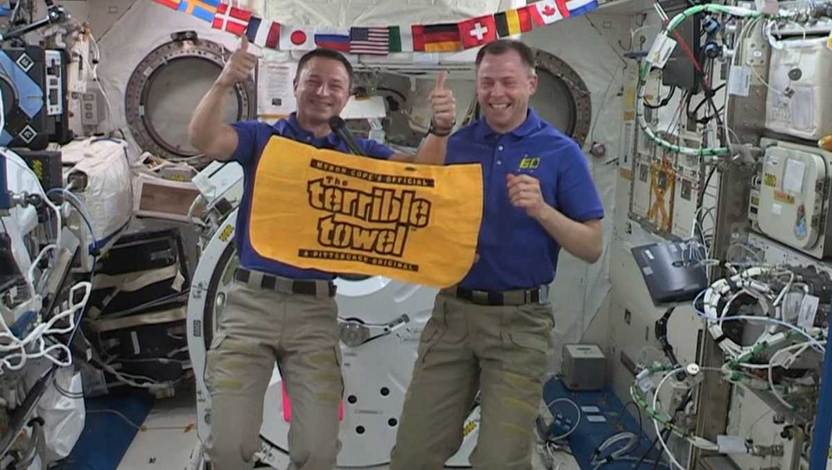 NASA Astronauts holding a terrible towel on board the International Space Station.