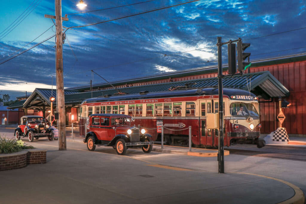 2 model a's with streetcar parked at safety island at museum